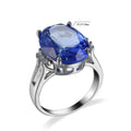 Geometric copper ring with blue black electroplated finish and an elliptical zircon centrepiece.