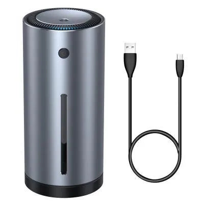 Black aluminium car humidifier and air purifier unit with USB cable on a car dashboard.