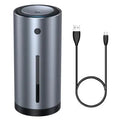 Black aluminium car humidifier and air purifier unit with USB cable on a car dashboard.