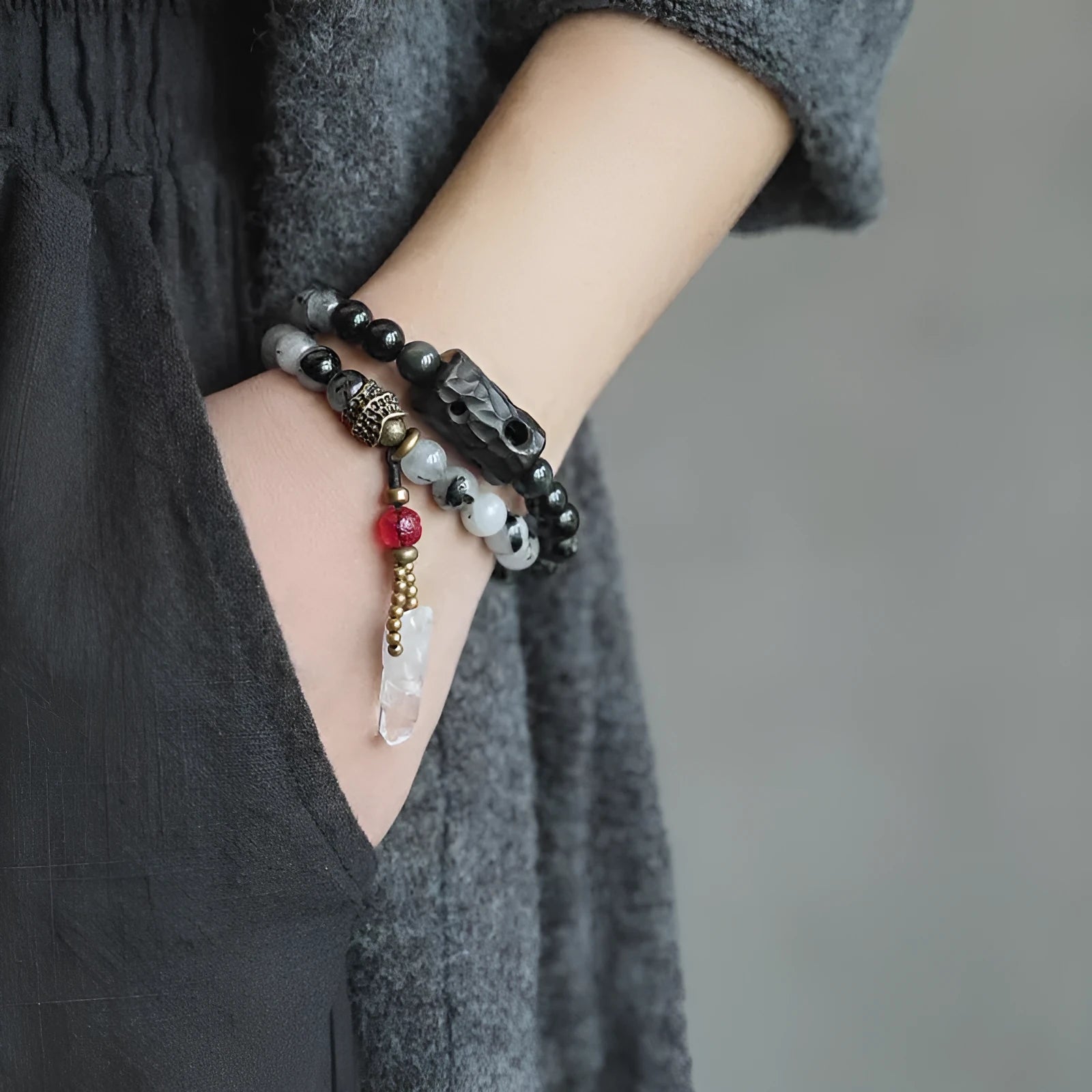 Ethnic black hair bracelet with white crystals and tassels showing bending lacing construction