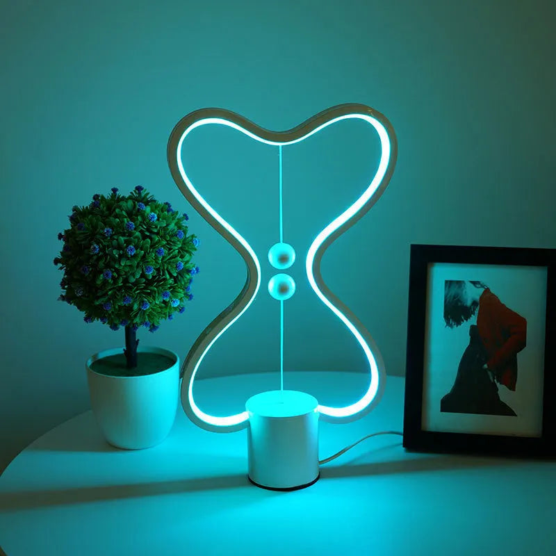 7-colour balance LED night light with magnetic suspension, USB powered, on a desk showing warm white glow