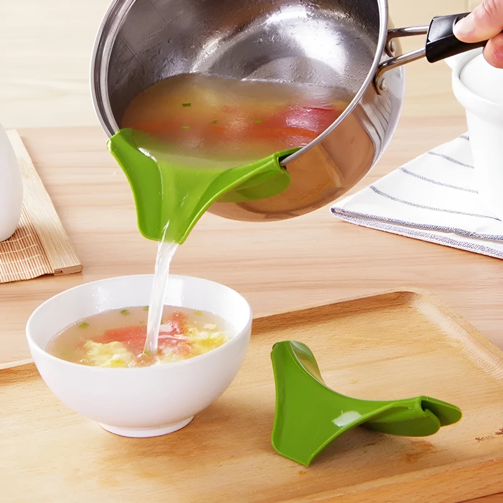 Green silicone kitchen funnel with clamp for securing to round pot edges