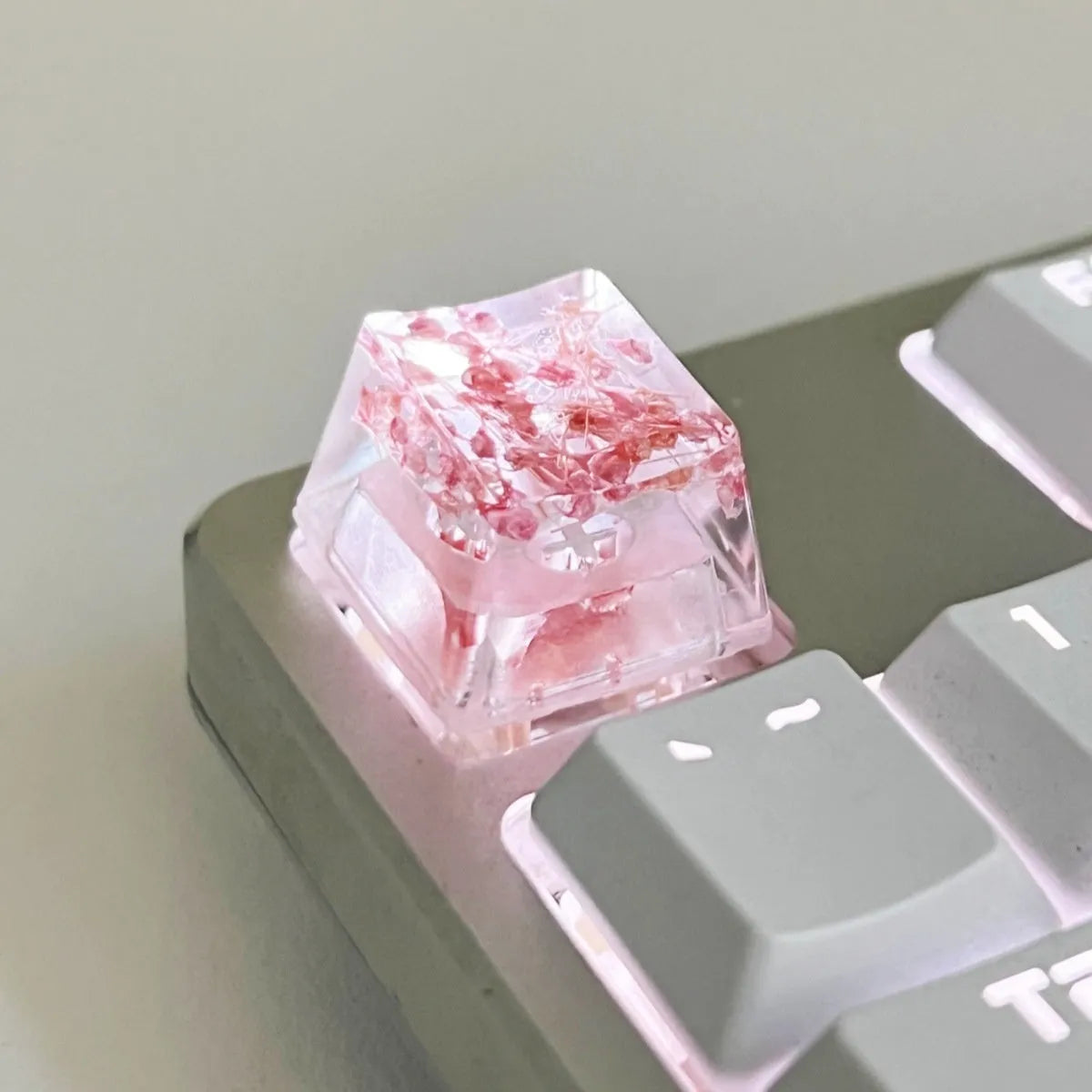 Transparent resin mechanical keyboard keycap with starry sky pattern in red, pink, green, and violet colour options