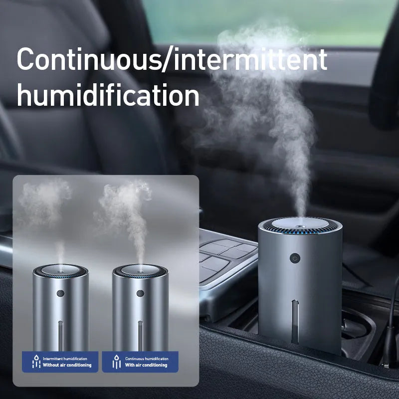 Black aluminium car humidifier and air purifier unit with USB cable on a car dashboard.