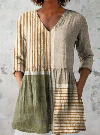 Women's floral wave print dress with wide waist and three-quarter length sleeves on a hanger.