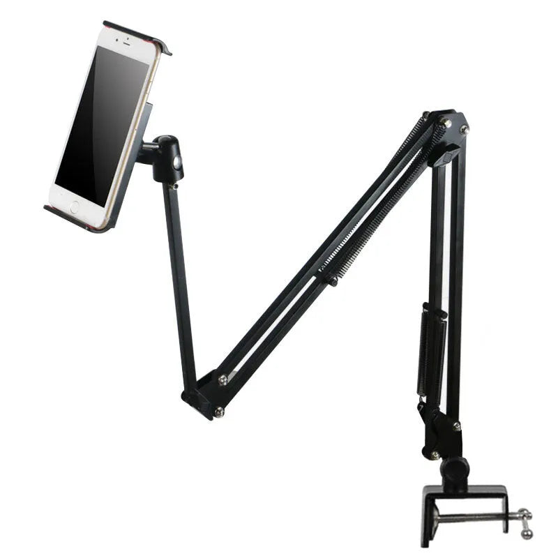 Black lazy mobile phone holder made of carbon steel and aluminium alloy placed on a bedside table.