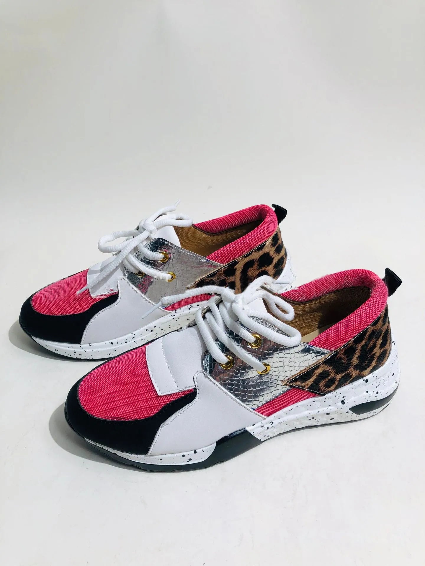 Women's casual suede sneakers with a wedge heel in black, leopard, pink, and snake pattern colours.