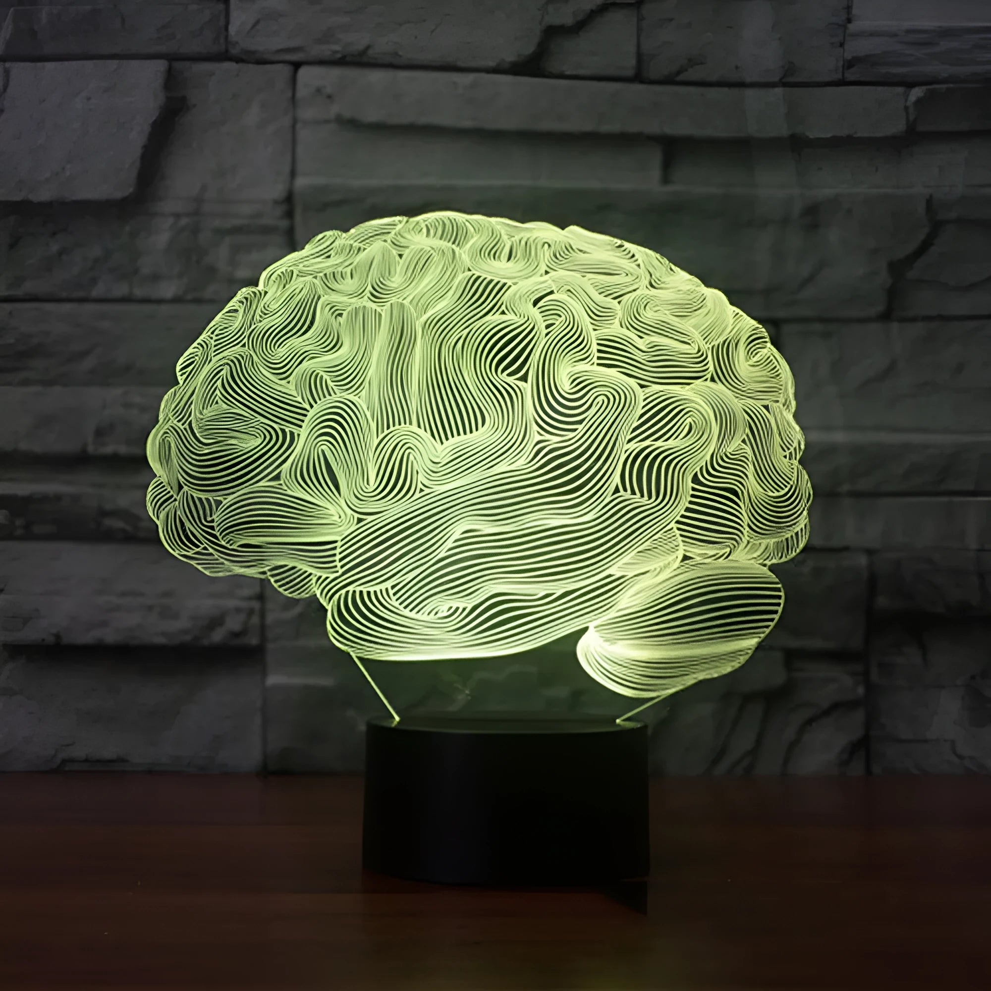 3D acrylic brain hologram LED desk lamp with black base and remote control on a wooden table.