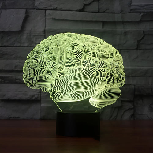 3D acrylic brain hologram LED desk lamp with black base and remote control on a wooden table.