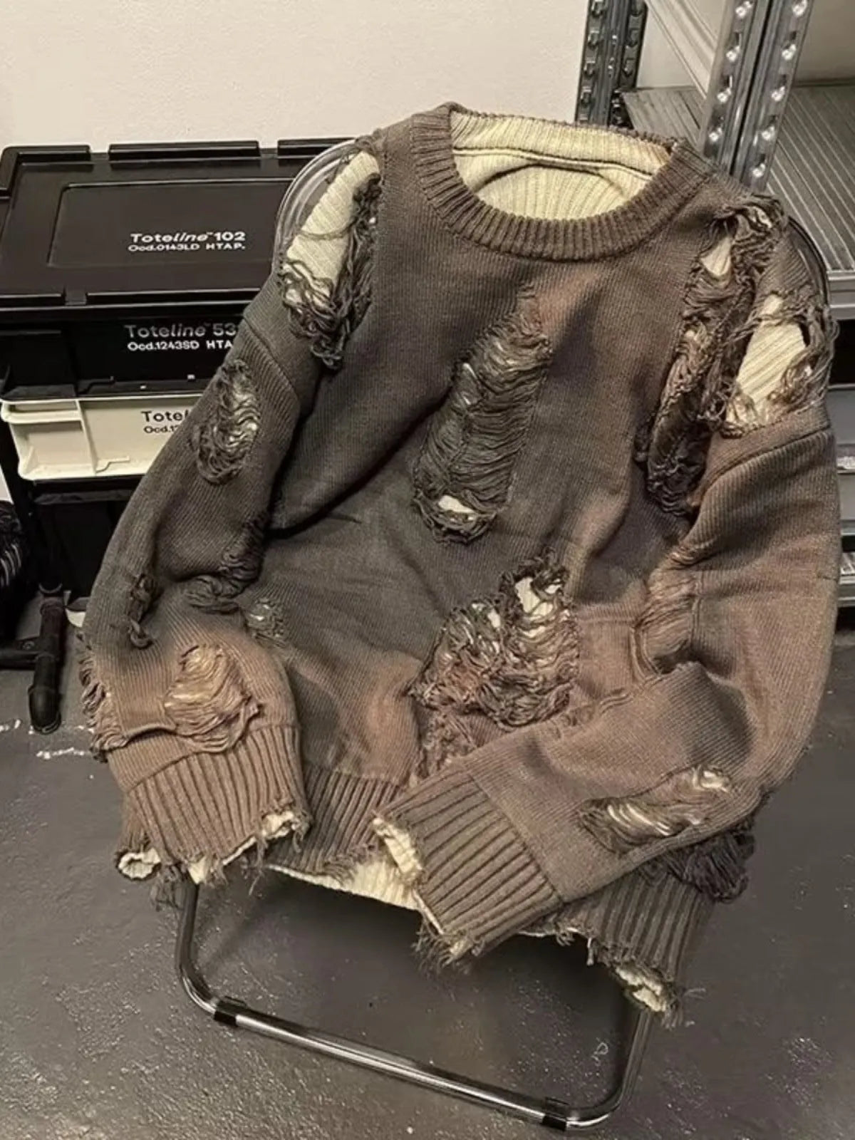 Men's black ripped sweater with animal pattern and tassels on front