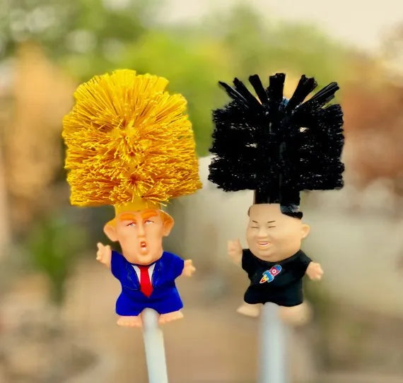 Yellow plastic Donald Trump toilet brush with hanging slot on handle.