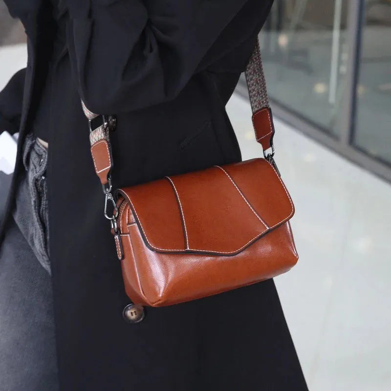 Top grain leather crossbody bag in caramel colour with zip closure and patchwork design