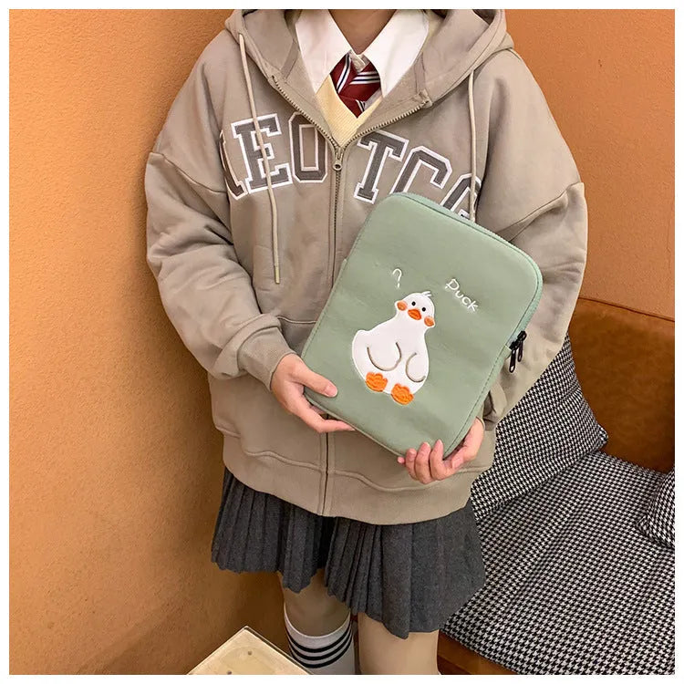 Blue cotton tablet case with cartoon duck embroidery and a zipper closure.