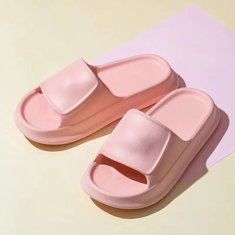 Pair of thick-soled EVA flip-flop slippers in a choice of seven colours, shown on a wet bathroom floor.
