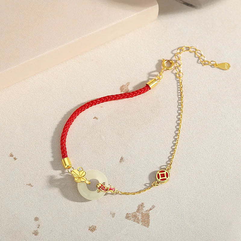 925 sterling silver red rope bracelet with a gold koi peace buckle safety clasp.