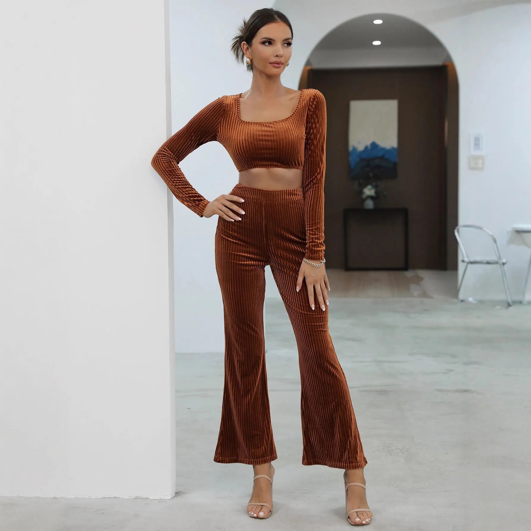 Women's caramel coloured sweater set with long sleeves and matching trousers on hanger