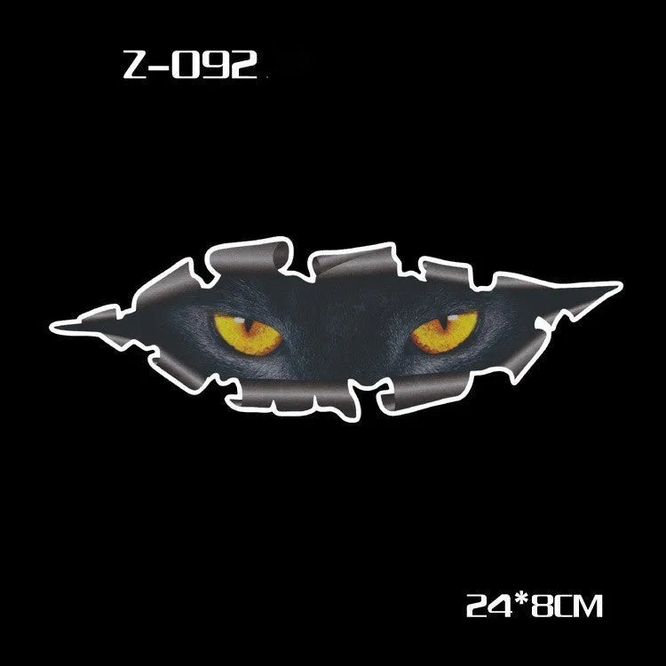 Pair of reflective cartoon eye car stickers on a vehicle rearview mirror.