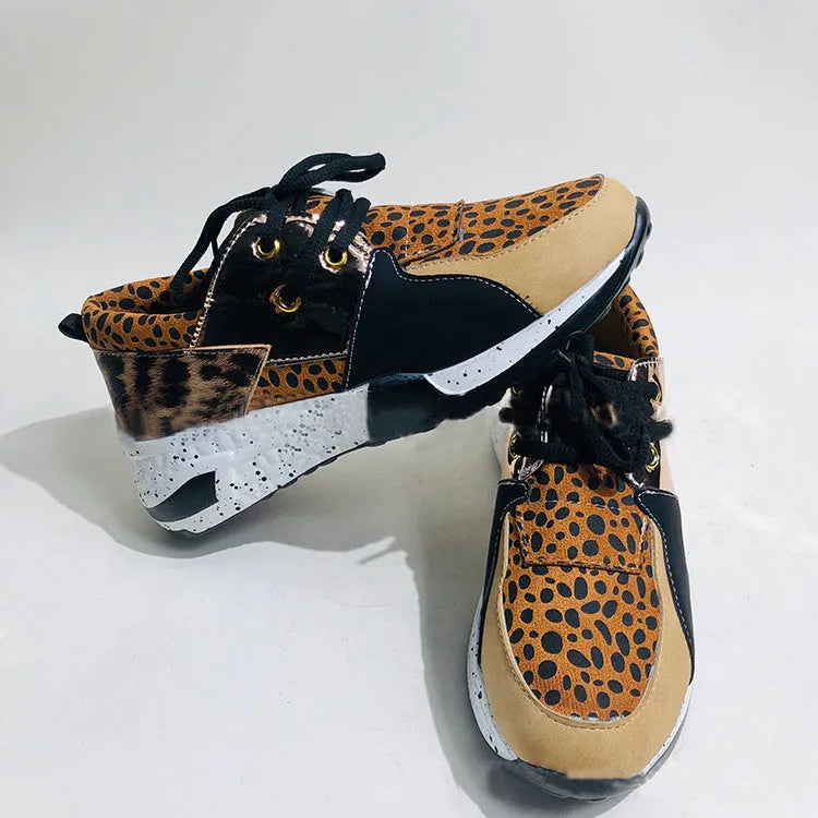 Women's casual suede sneakers with a wedge heel in black, leopard, pink, and snake pattern colours.
