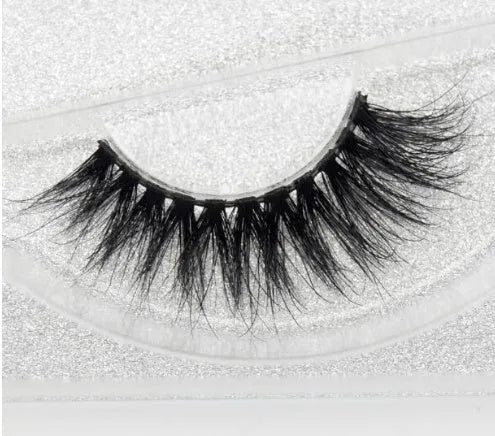 Pair of faux mink eyelashes with long tail and cotton stem against white background