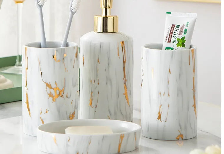 White ceramic bathroom wash set with marble finish showing two cups, soap box, and latex bottle