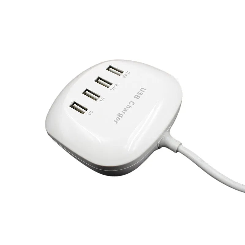 White dual USB wall charger with EU plug style next to smartphone and tablet