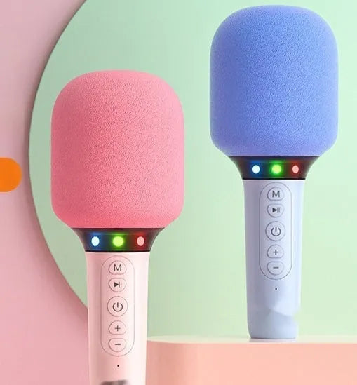 Pink Bluetooth children's handheld karaoke microphone with built-in speaker on white background