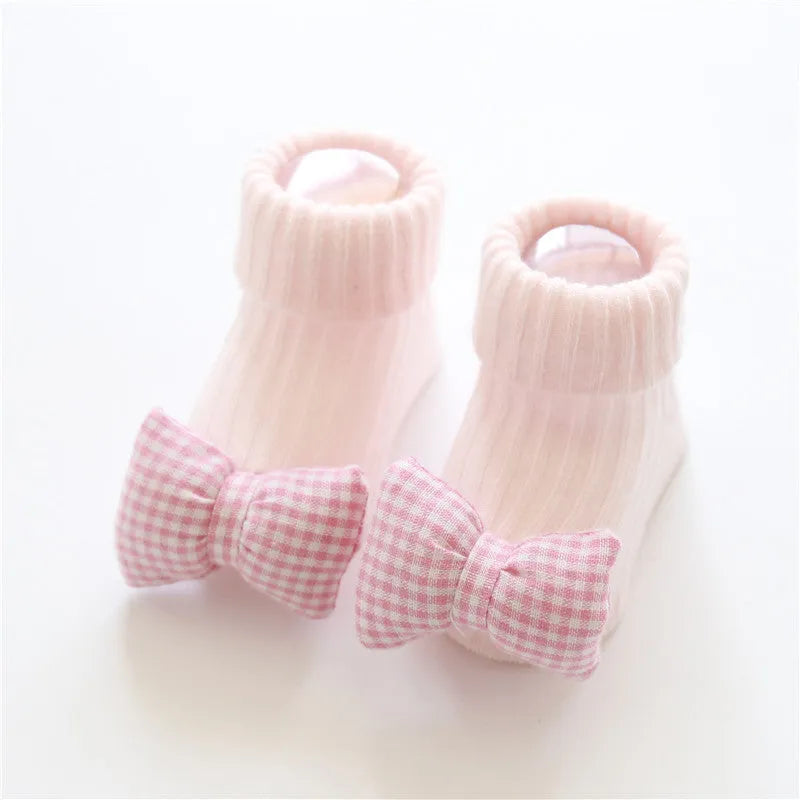Cotton baby floor socks in multiple designs including panda, bow, and star patterns.