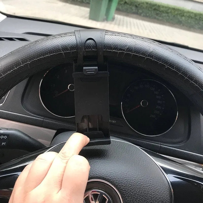 Black universal steering wheel phone clip holder mounted with a smartphone displaying a map.