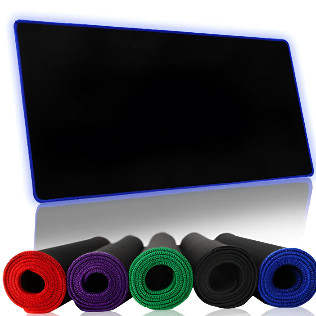 Solid colour locking edge large gaming mouse mat in black, 30x60 cm, on desk with keyboard and mouse