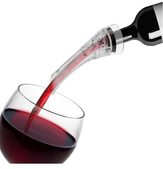 A clear acrylic wine aerator with a stainless steel filter, shown next to a wine glass.