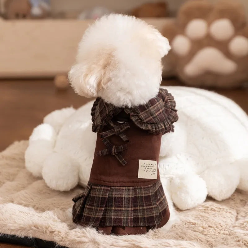 Fleece-lined brown plaid pet sweater dress with ruffle trim on a small dog, showing stretchable knit and skirt silhouette