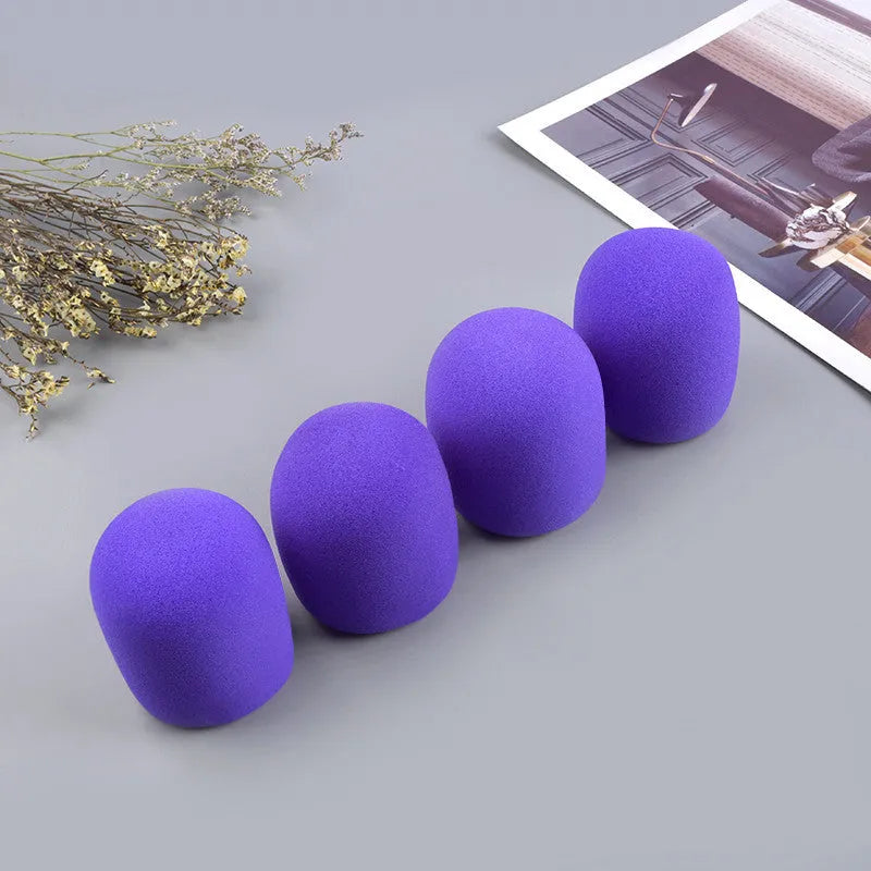 Four multicoloured foam microphone windshields for ball-shaped handheld stage microphones
