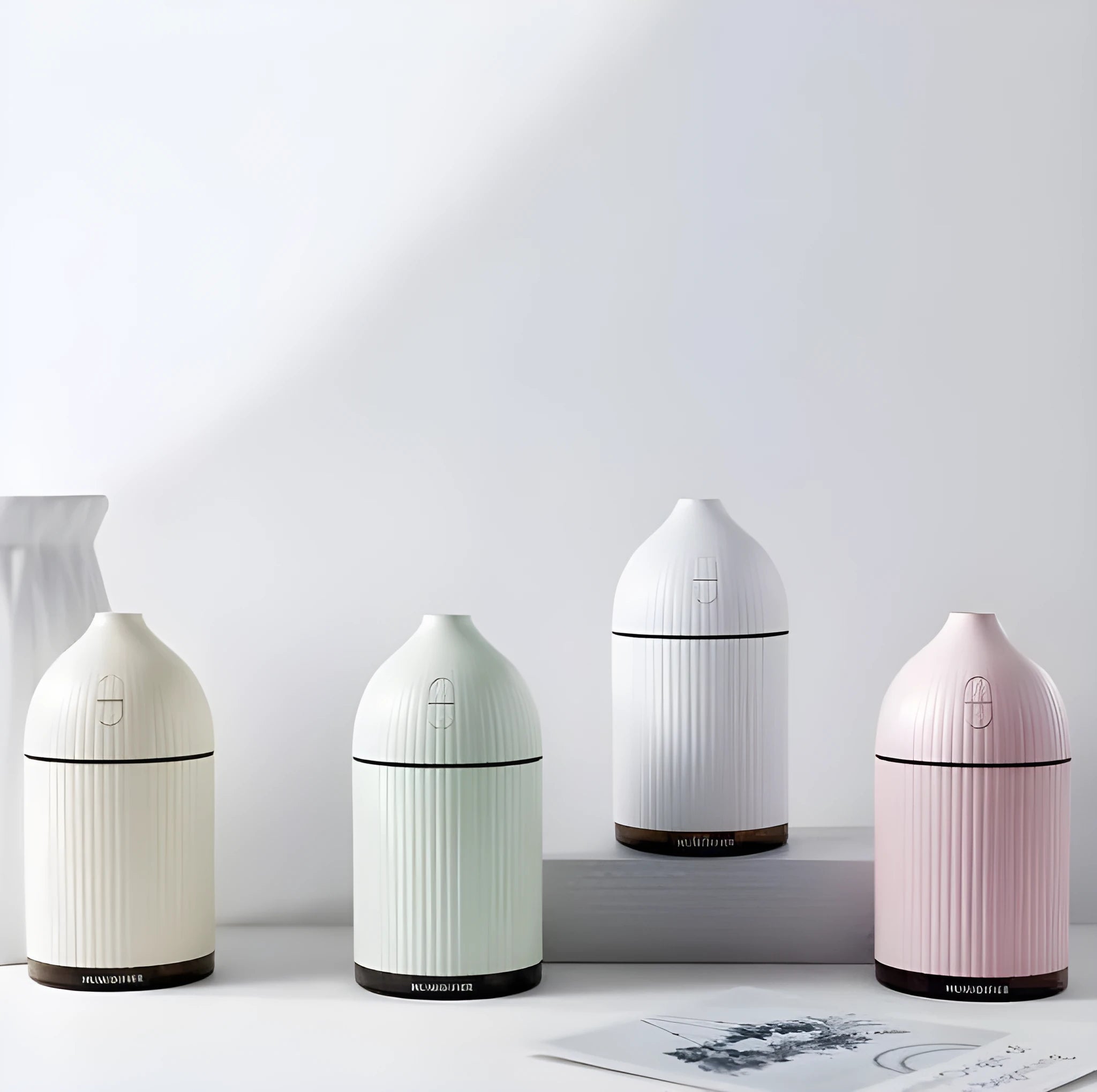 White USB aroma diffuser and humidifier with 300ml tank and LED light on a wooden surface.
