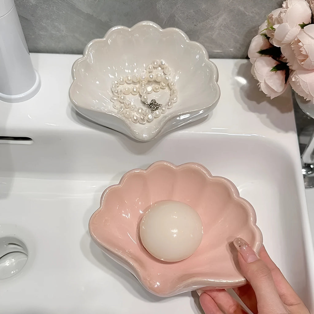 Shell-shaped plastic soap dish in pearl white or cherry blossom pink for bathroom storage