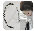 Unisex wavy black alloy headband hair ring on a flat surface