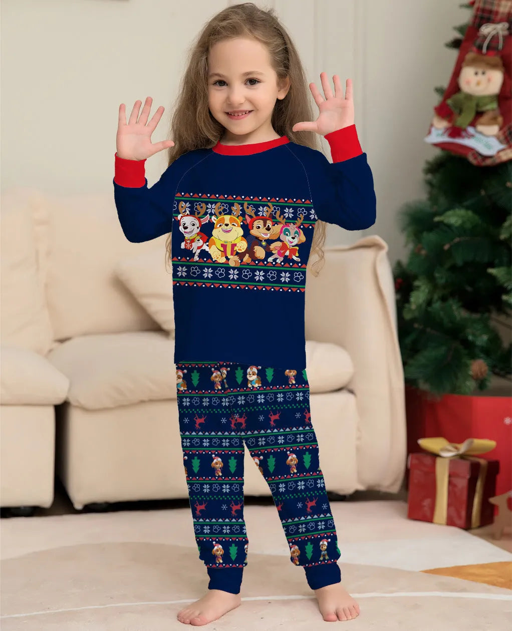 Red and black plaid Christmas pajama set with deer print, shown on matching family members including a dog.