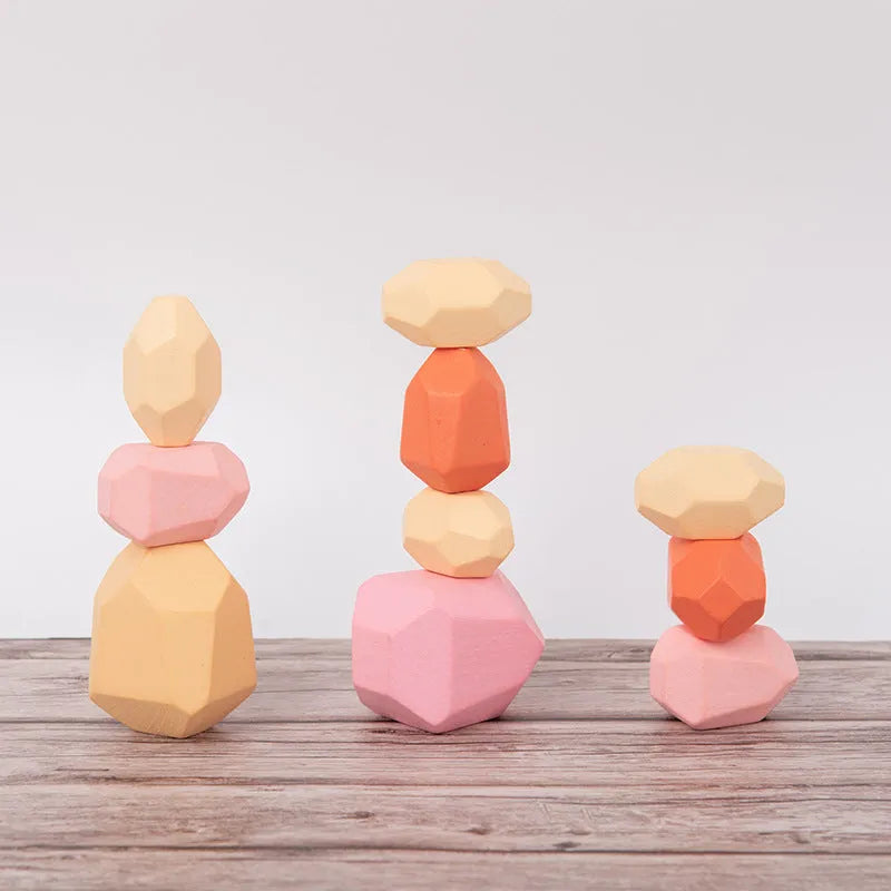 Wooden building block set with coloured and natural stone stacks on a table, suitable for children aged 4-6