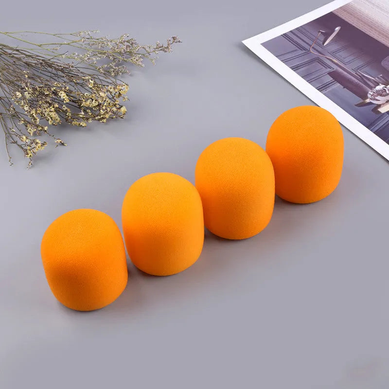 Four multicoloured foam microphone windshields for ball-shaped handheld stage microphones