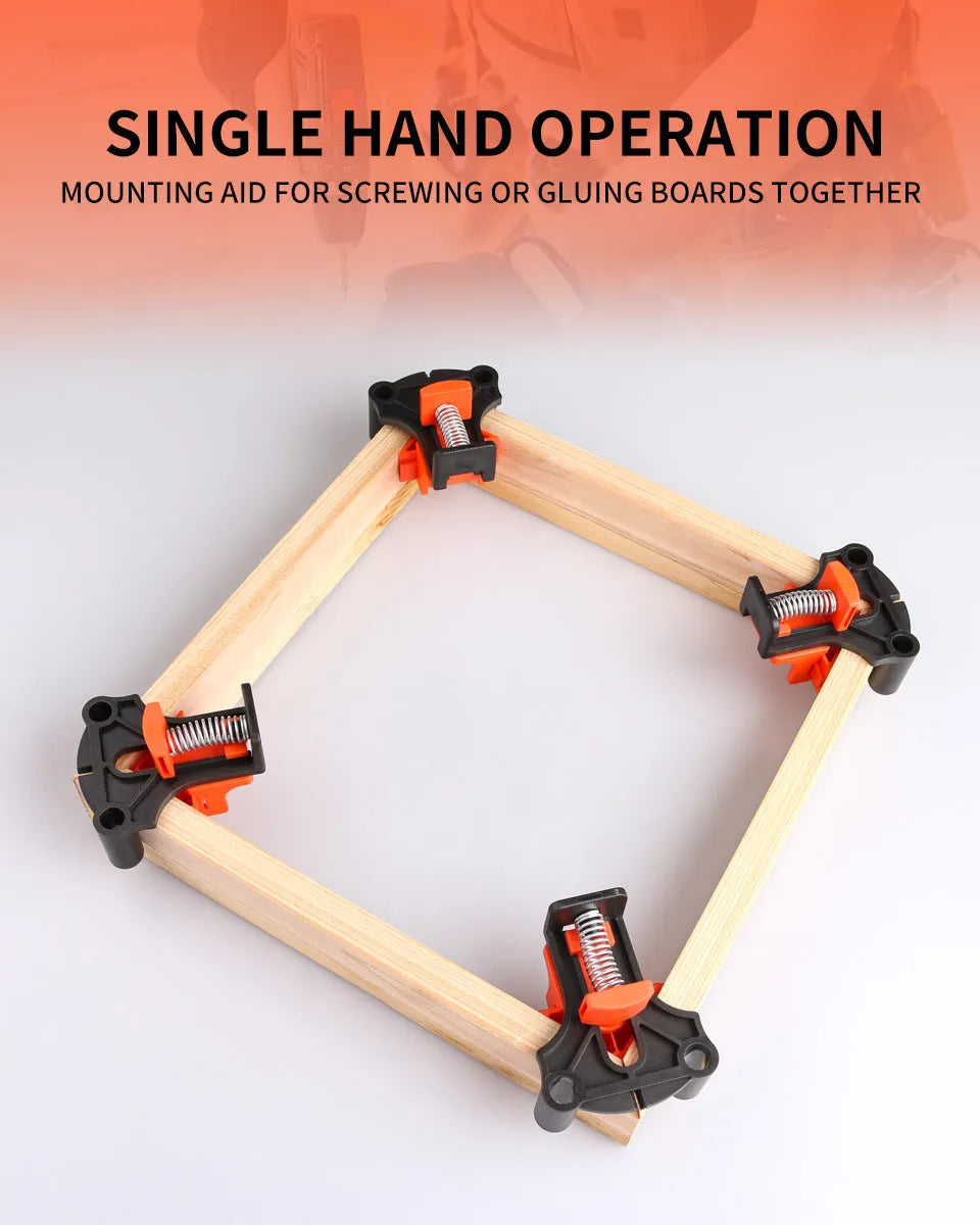 Set of four white plastic right angle clamps for picture frame assembly on a wooden surface.