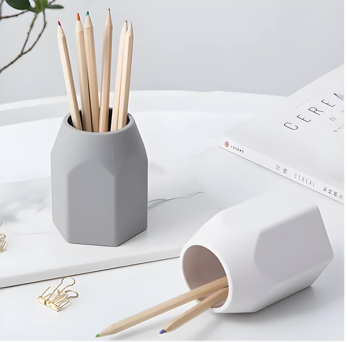 Round solid silicone pen holder in grey on a desk with pens inserted, 80x95mm
