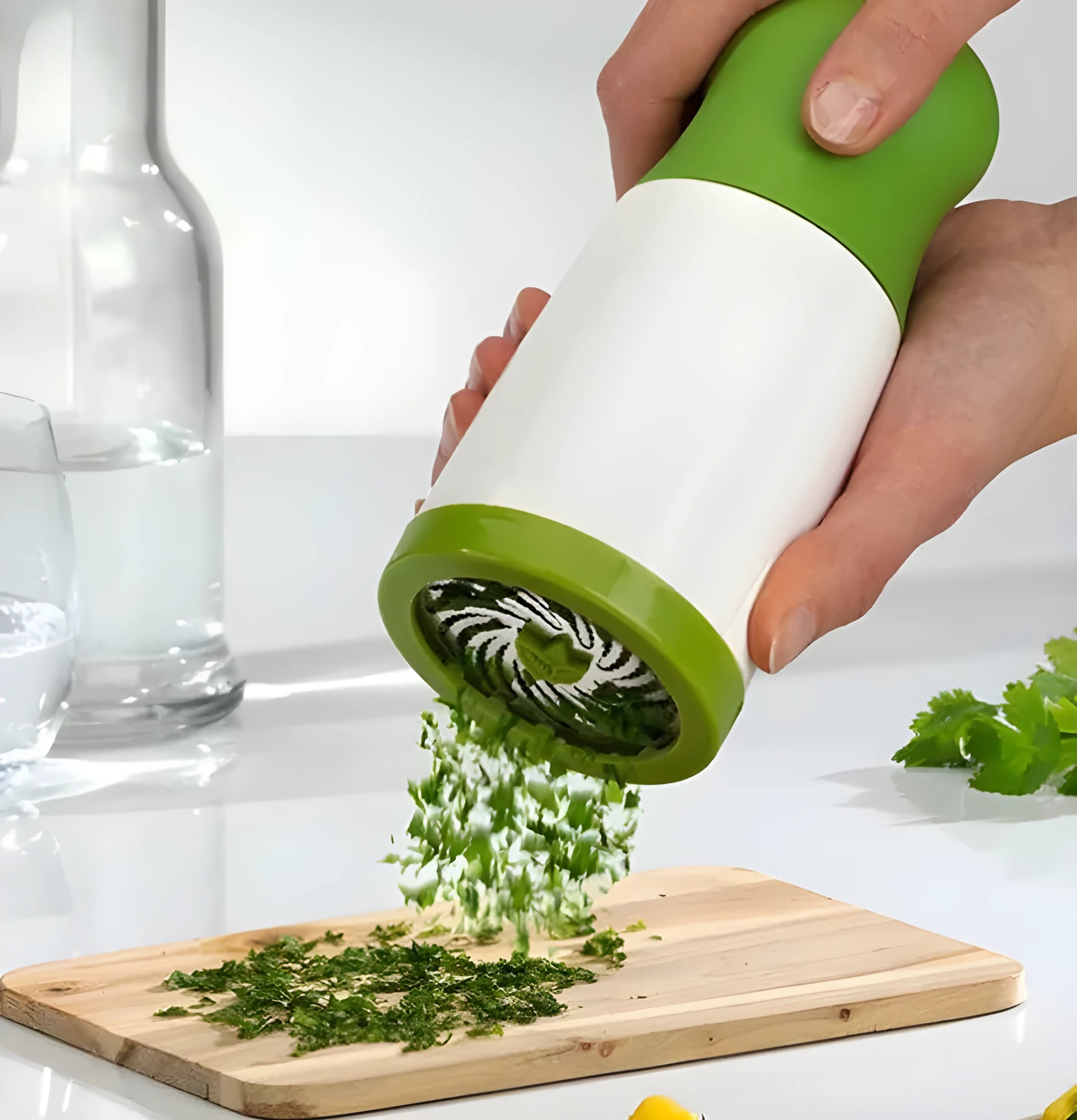 White and silver herb grinder spice mill with removable top on a kitchen counter.