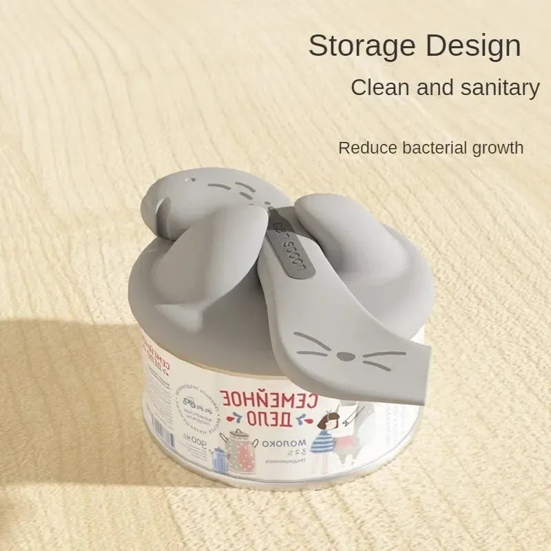 Silicone pet food mixing spoon and flexible can sealing lids in grey, pink and yellow colours.