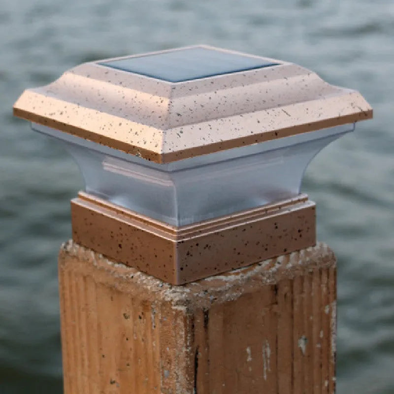 Outdoor solar column headlight XNZ-0012 in white light mode on a garden pillar