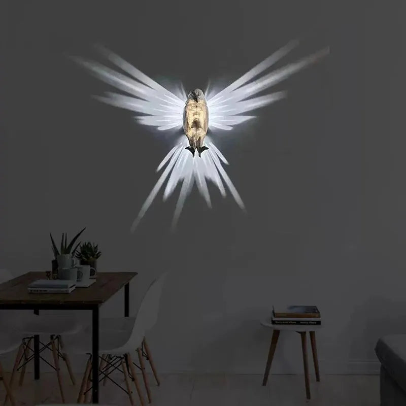 Eagle-shaped 3D printed resin wall lamp projecting a silhouette shadow on a wall.