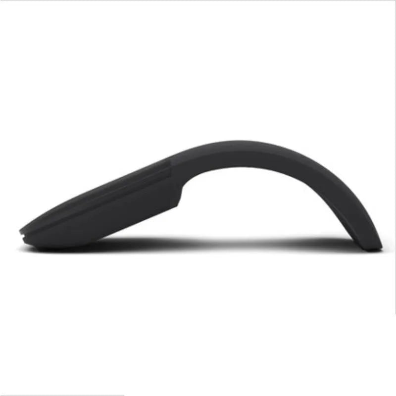 Black folding Bluetooth wireless mouse shown both folded and unfolded beside laptop