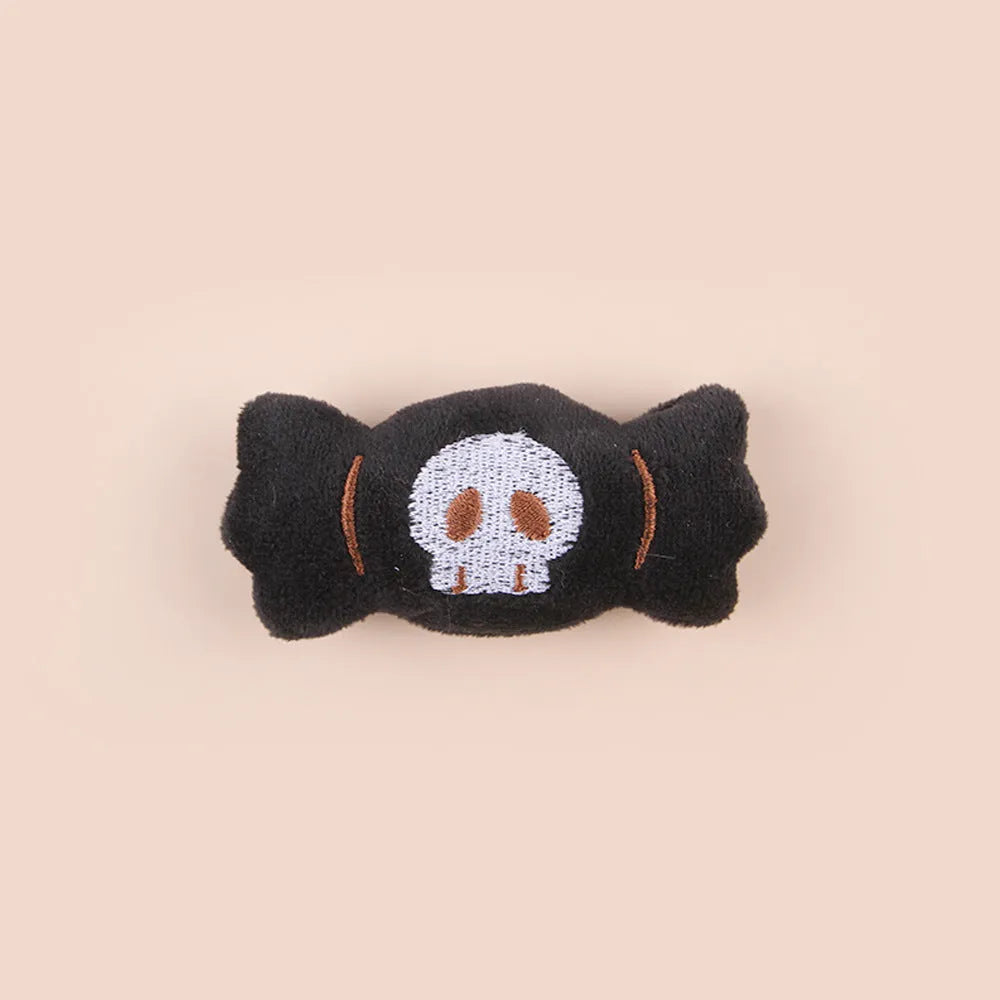 Small handheld cat teaser with plush candy and eyes attachments on wand