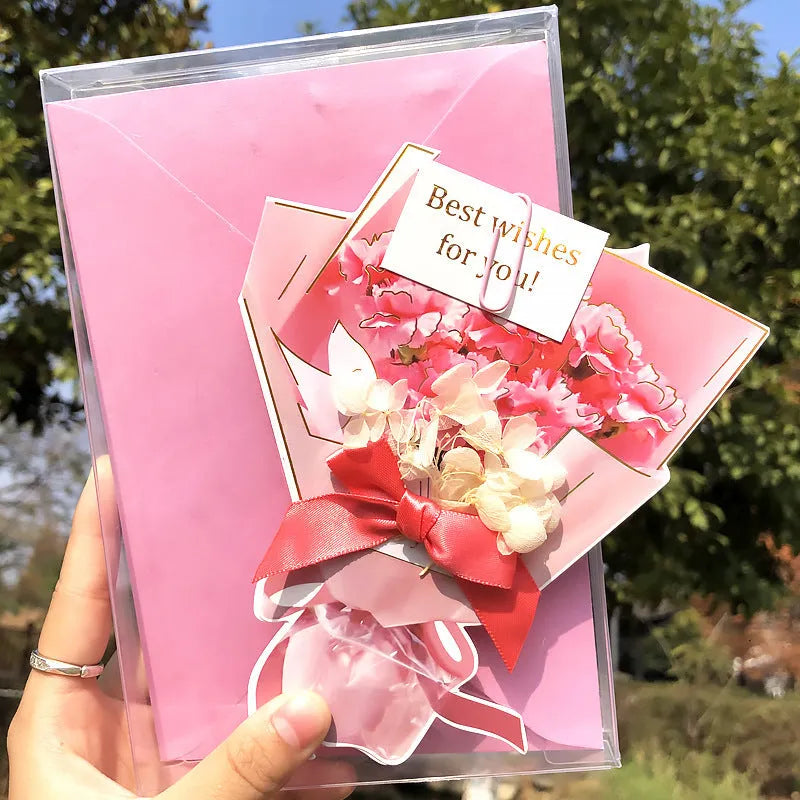 Handmade 3D butterfly-shaped greeting card with artificial flowers in a box, alongside its matching envelope.