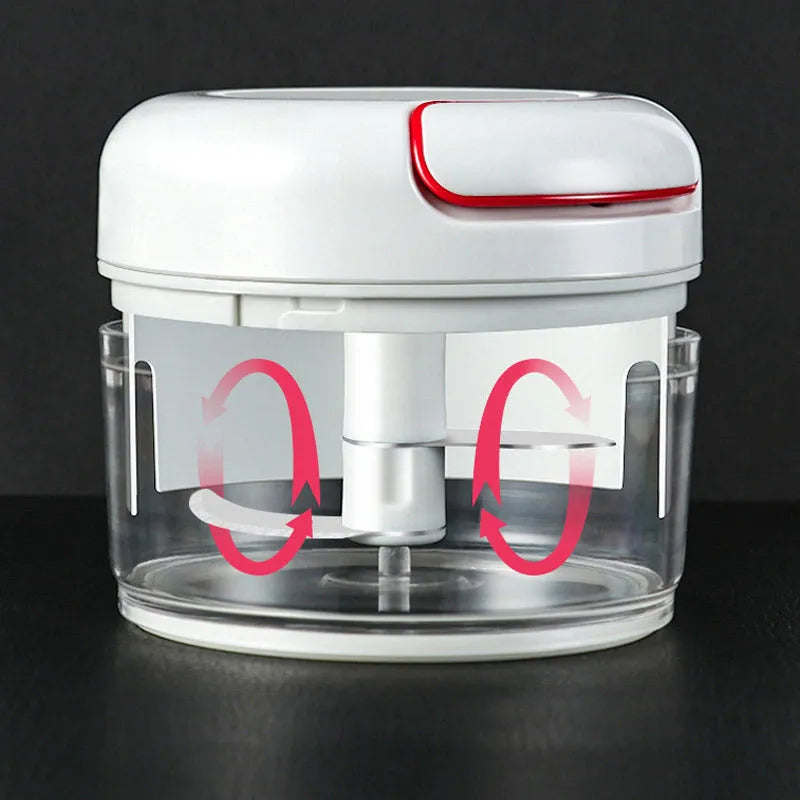 White and silver manual food chopper with stainless steel blades on a kitchen countertop.