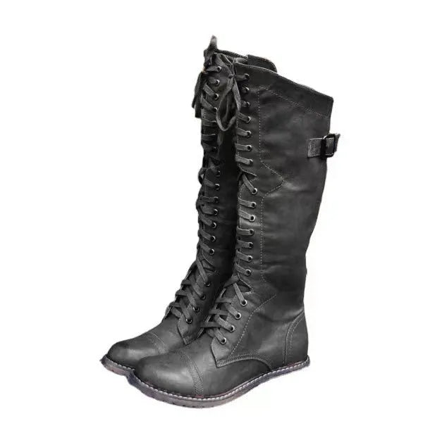 Black women's chunky heel high-leg boots with a round toe and short stout heel on a plain background.
