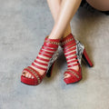 Women's black snake print high-top shoes with a thick Roman-style block heel and rubber sole.